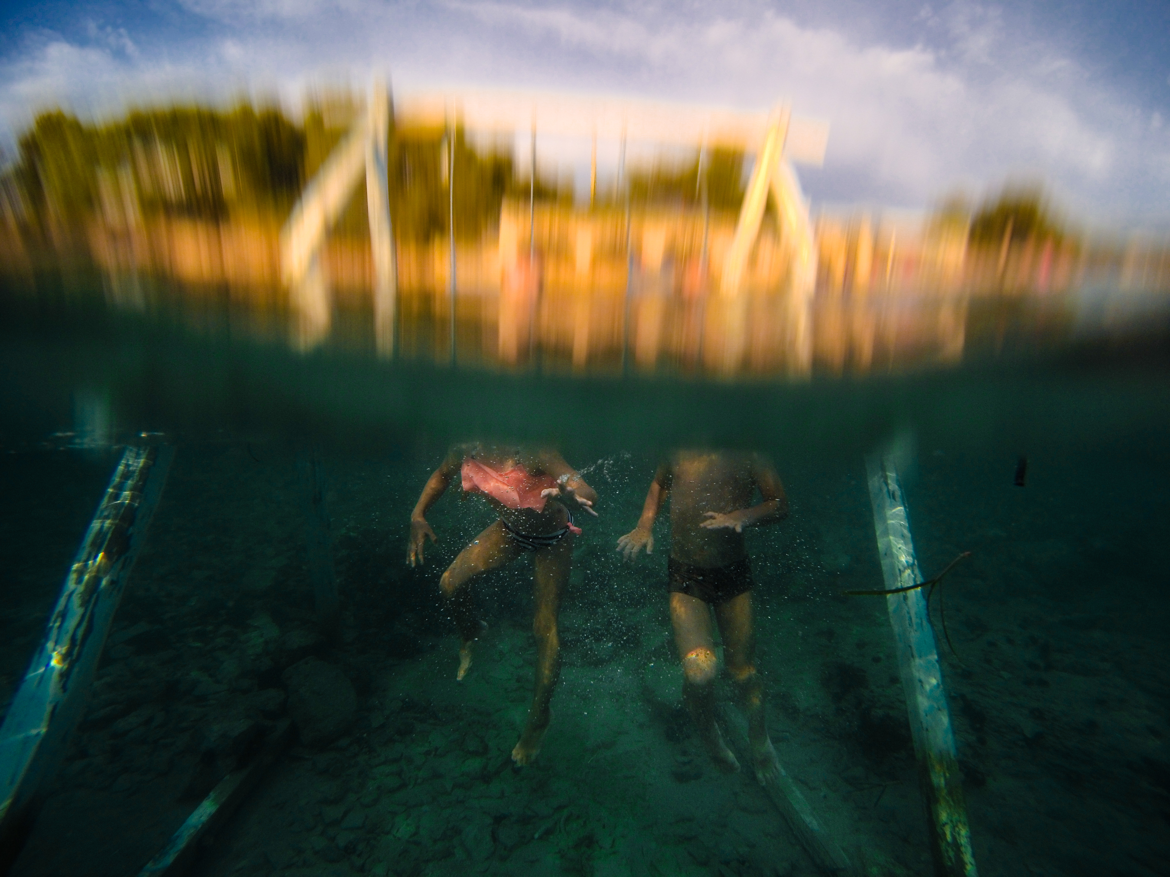 underwater photography two kids in the sea swings