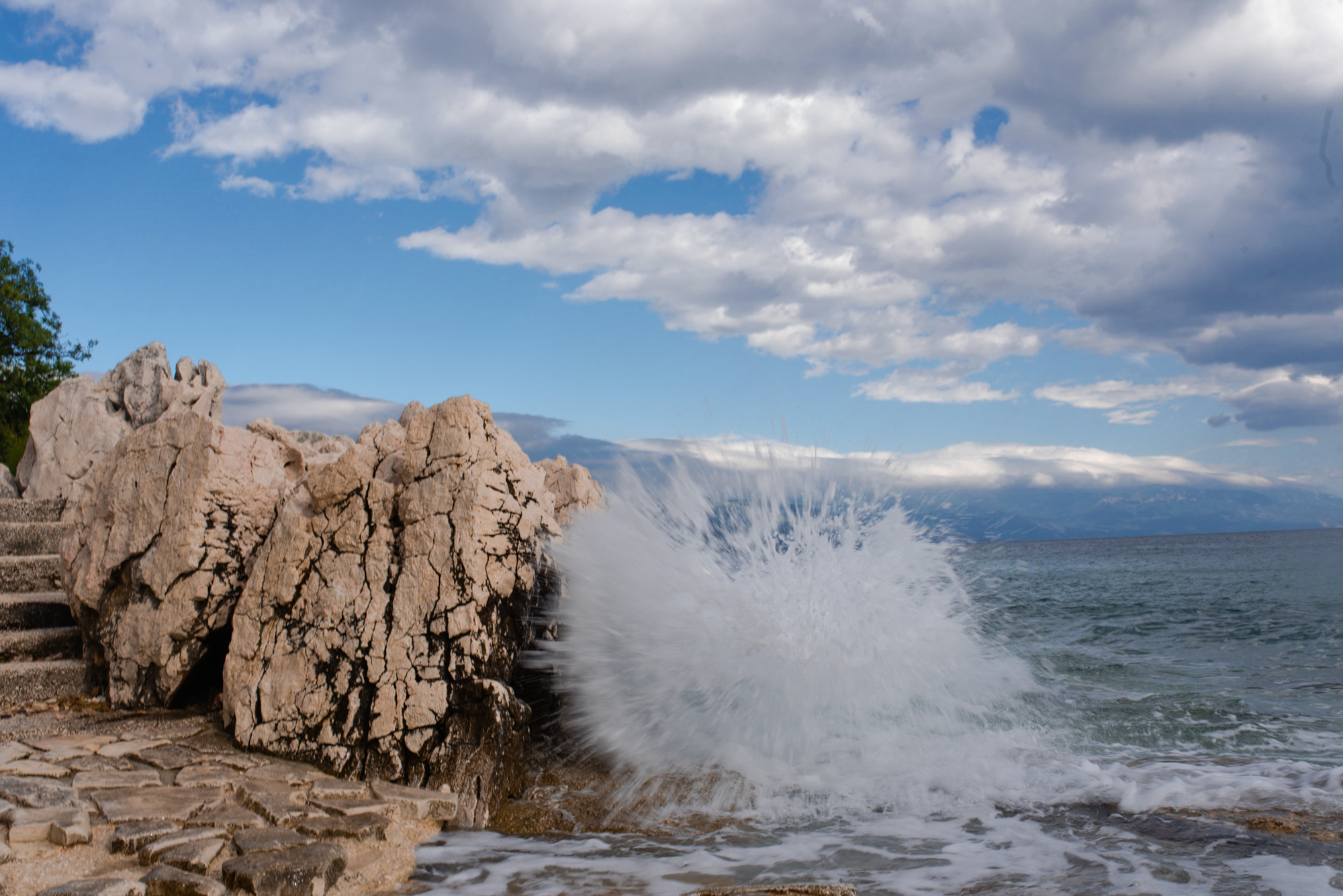 sea vaves breaking rocks clouds