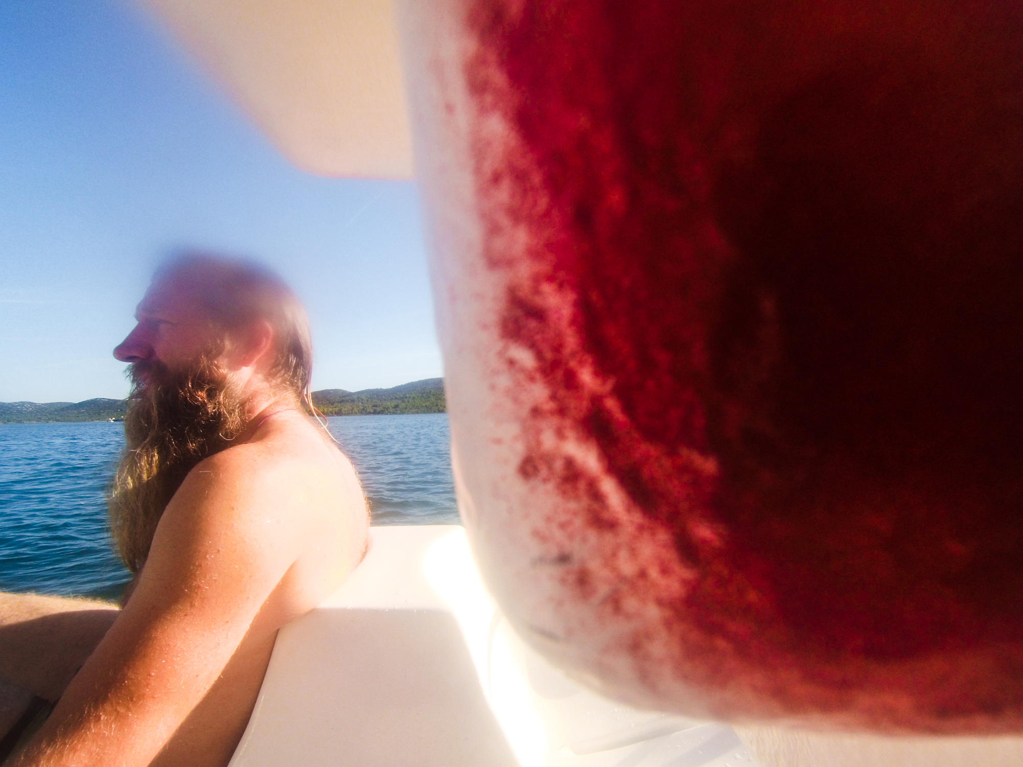 a man with very long beard sitting in the paddle board intensive red Croatia